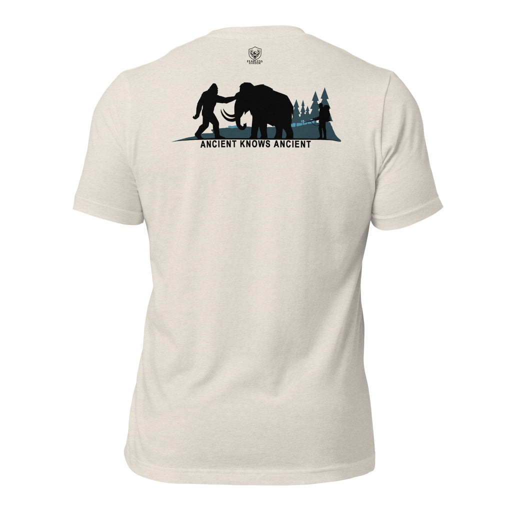 Men’s heather dust prehistoric hunting tee with ancient mammoth hunter scene and Bigfoot silhouette