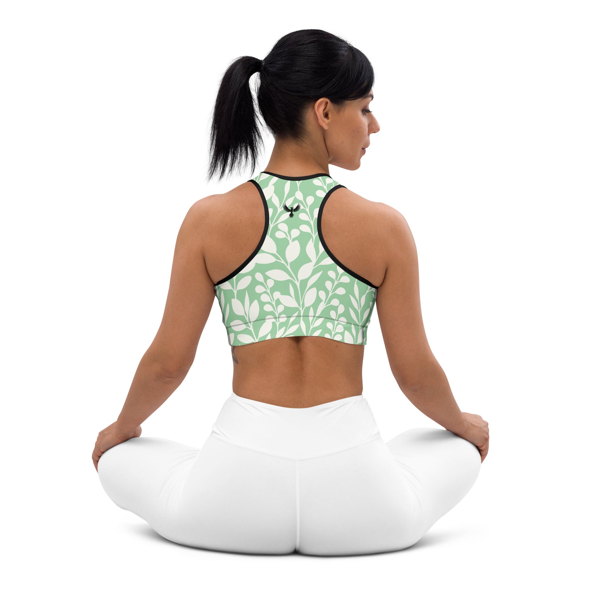 Back of Racerback Embrace Fearless Growth Sports Bra in Green and White plant design, black trim, phoenix logo on center.