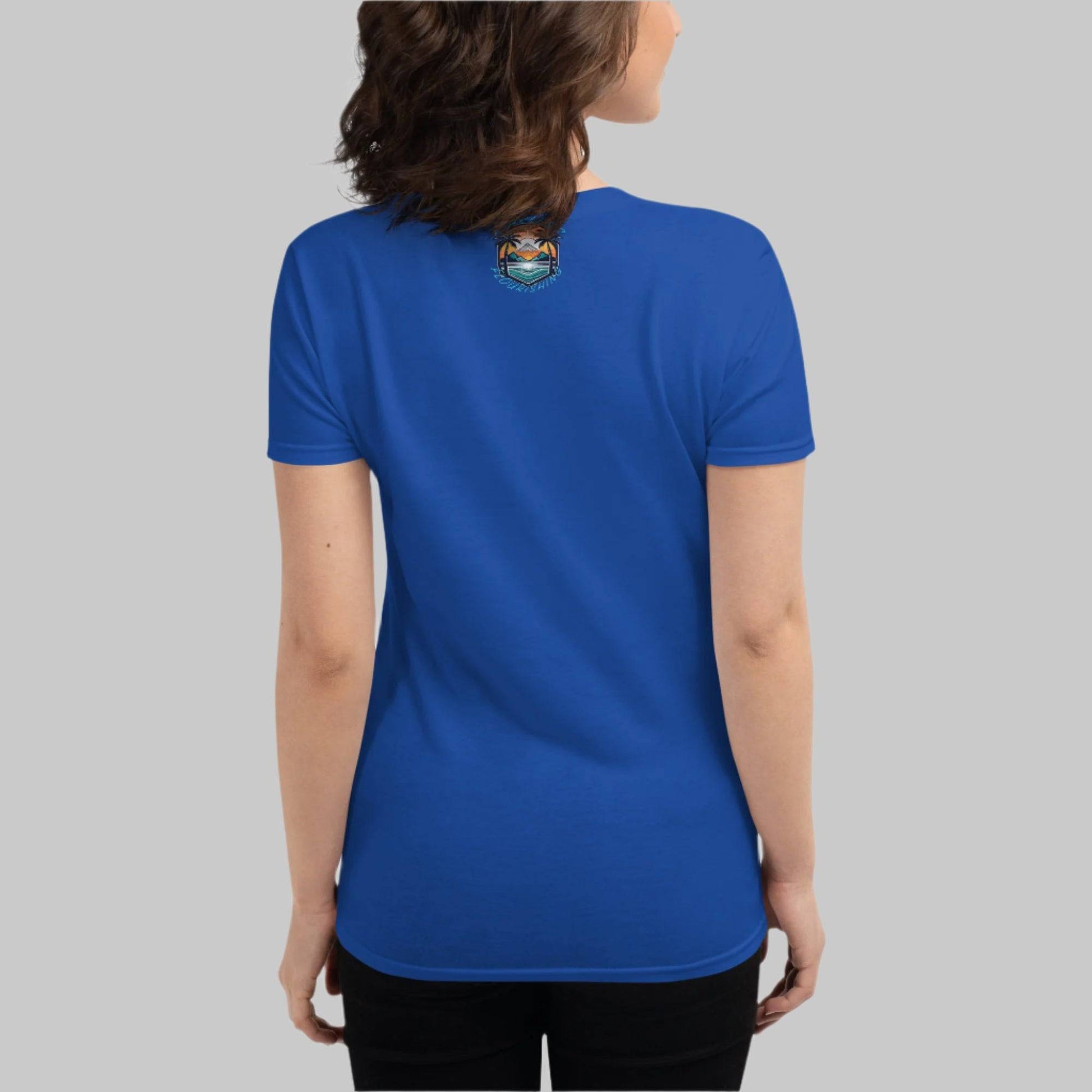 Back of Woman wearing T-Shirt in Blue with Beach logo on top center near collar and the words Fearless Flourishing.